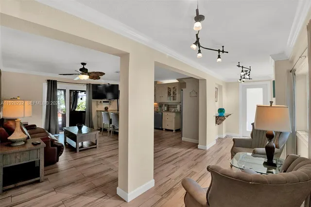 a living room with furniture and wooden floor