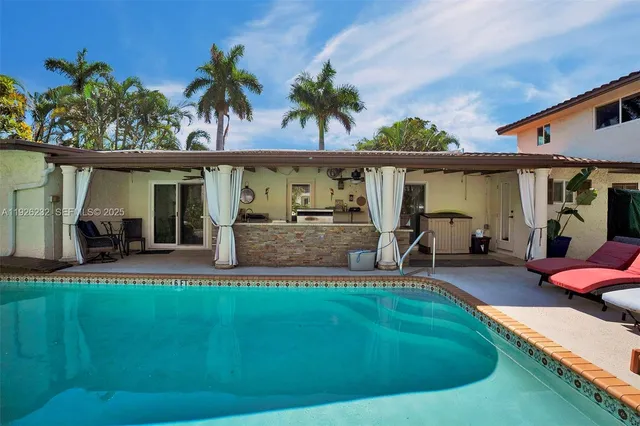 a view of a patio with table and chairs potted plants and palm tree