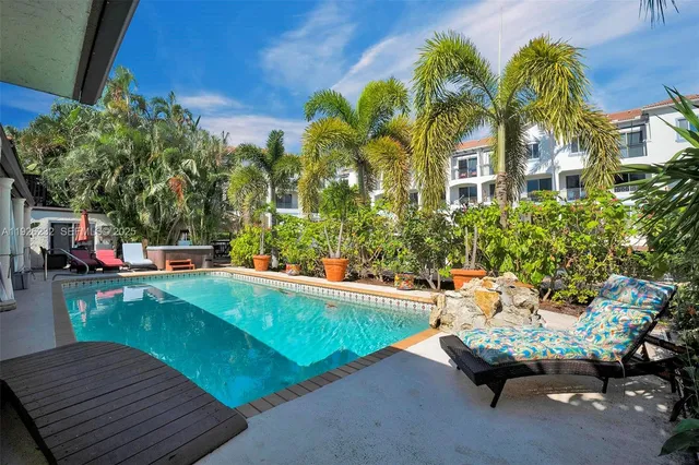 a backyard of a house with barbeque oven table and chairs