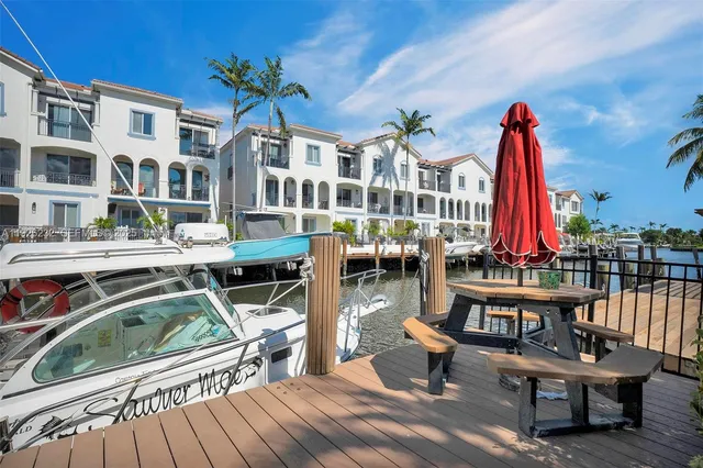 a view of a rooftop with chairs and wooden floor