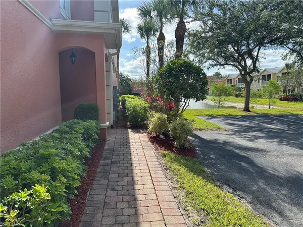 a view of a pathway with a house in the background