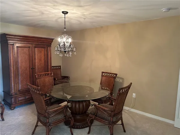 a dining room with furniture and chandelier