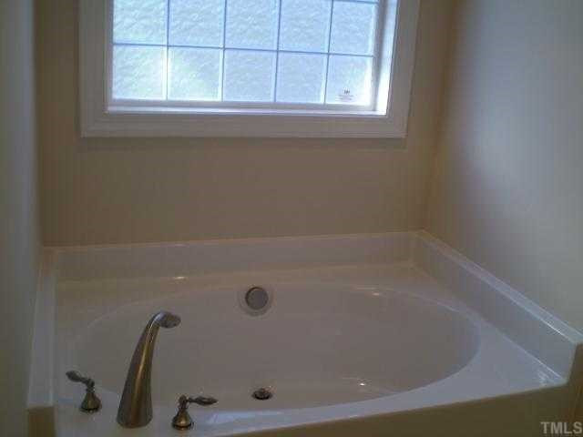 5720 Spring Glen Lane Raleigh, NC 27616 - Photo 9 of 12 Master bathroom with garden tub and separate shower