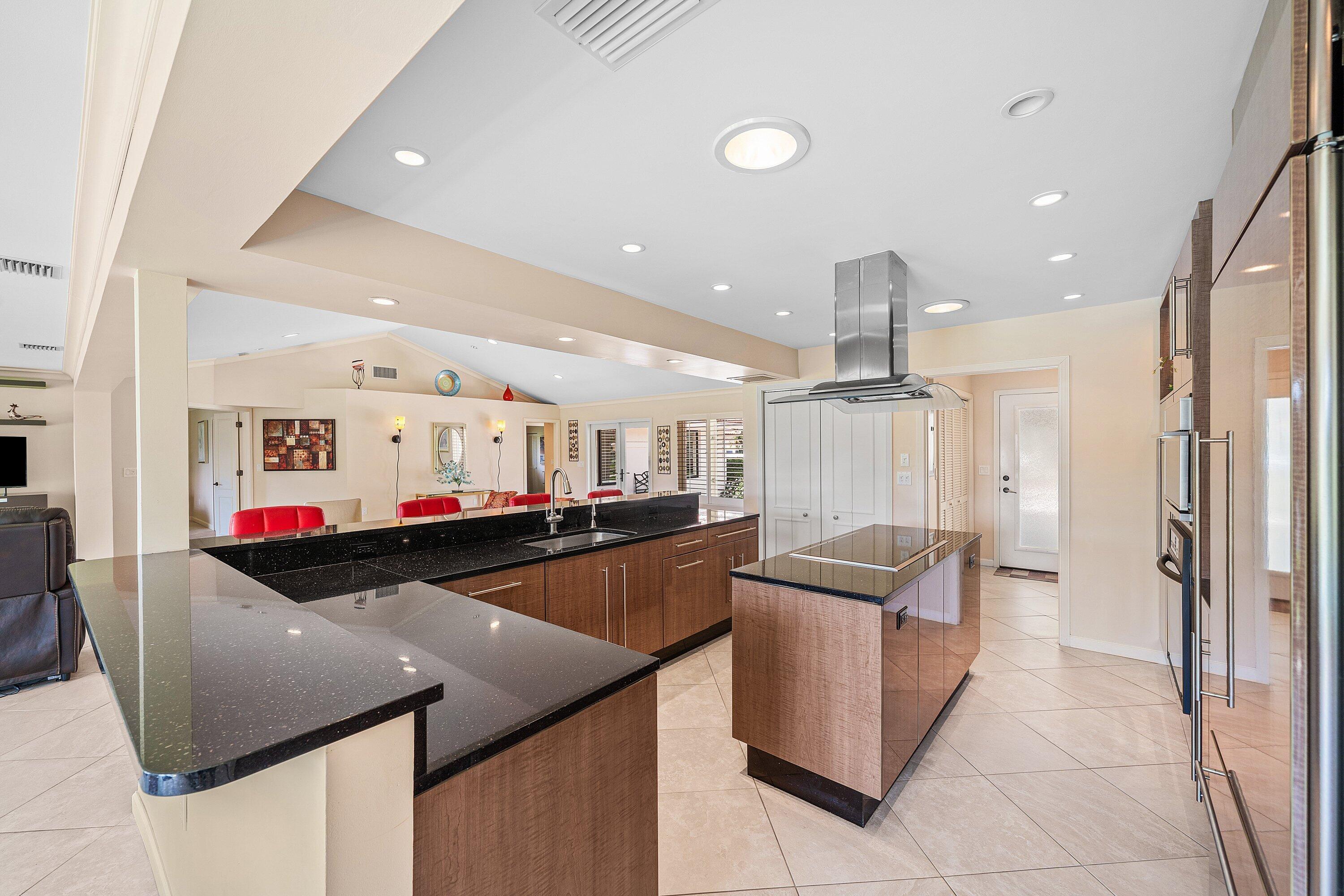 4365 Shell Drake Lane Boynton Beach, FL 33436 - Photo 15 of 56 a kitchen with stainless steel appliances granite countertop a sink and a refrigerator