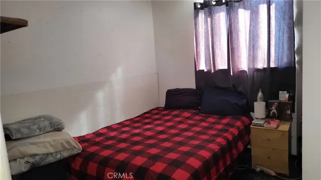 a bedroom with a bed and window
