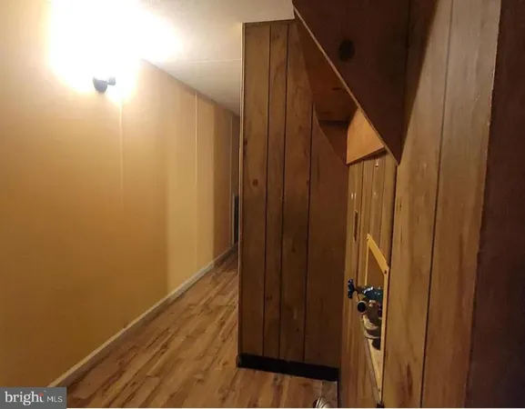 a view of hallway with wooden floor