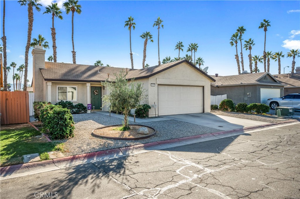 47800 Madison Street, Unit 174 Indio, CA 92201 - Photo 1 of 24 a front view of a house with a garden