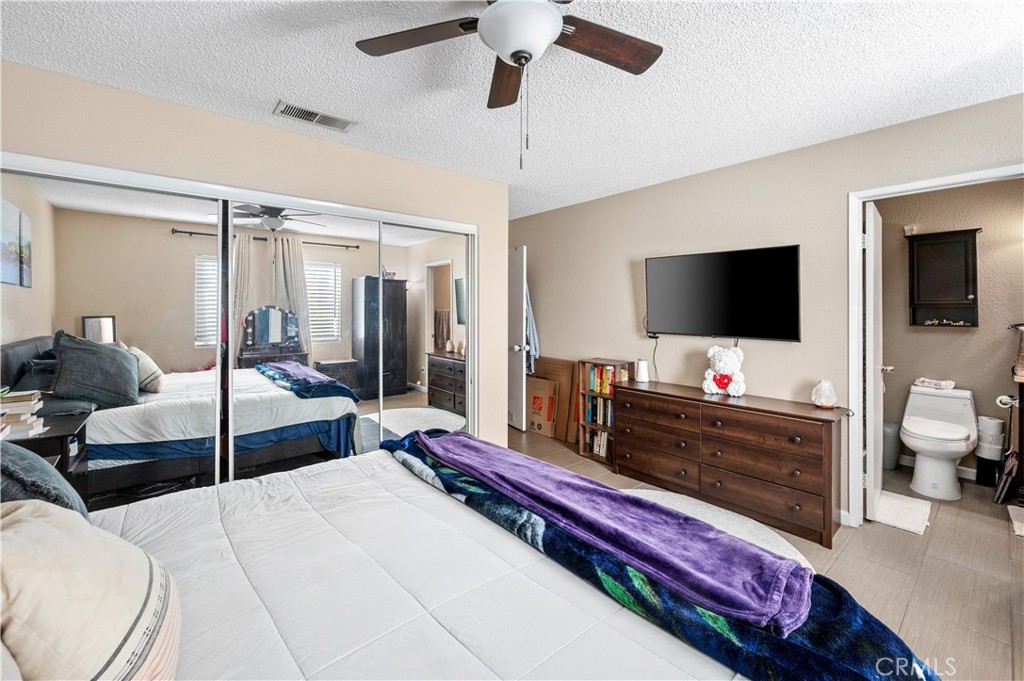 47800 Madison Street, Unit 174 Indio, CA 92201 - Photo 12 of 24 a bedroom with a bed and a flat screen television