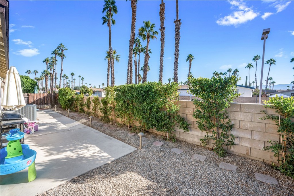 47800 Madison Street, Unit 174 Indio, CA 92201 - Photo 20 of 24 a view of a house with a yard