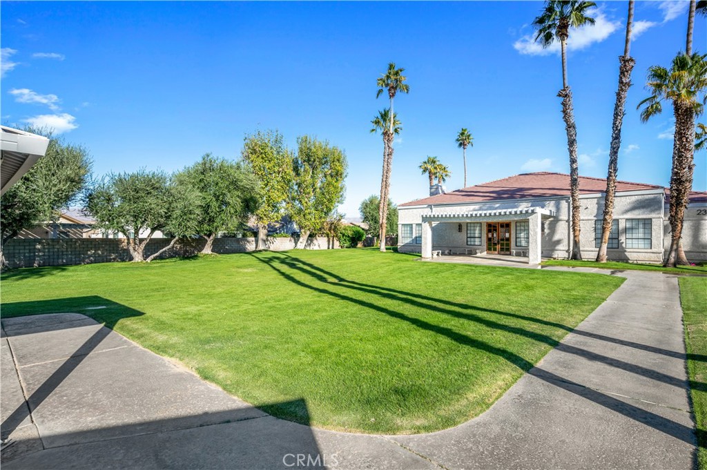 47800 Madison Street, Unit 174 Indio, CA 92201 - Photo 21 of 24 a front view of a house with a yard
