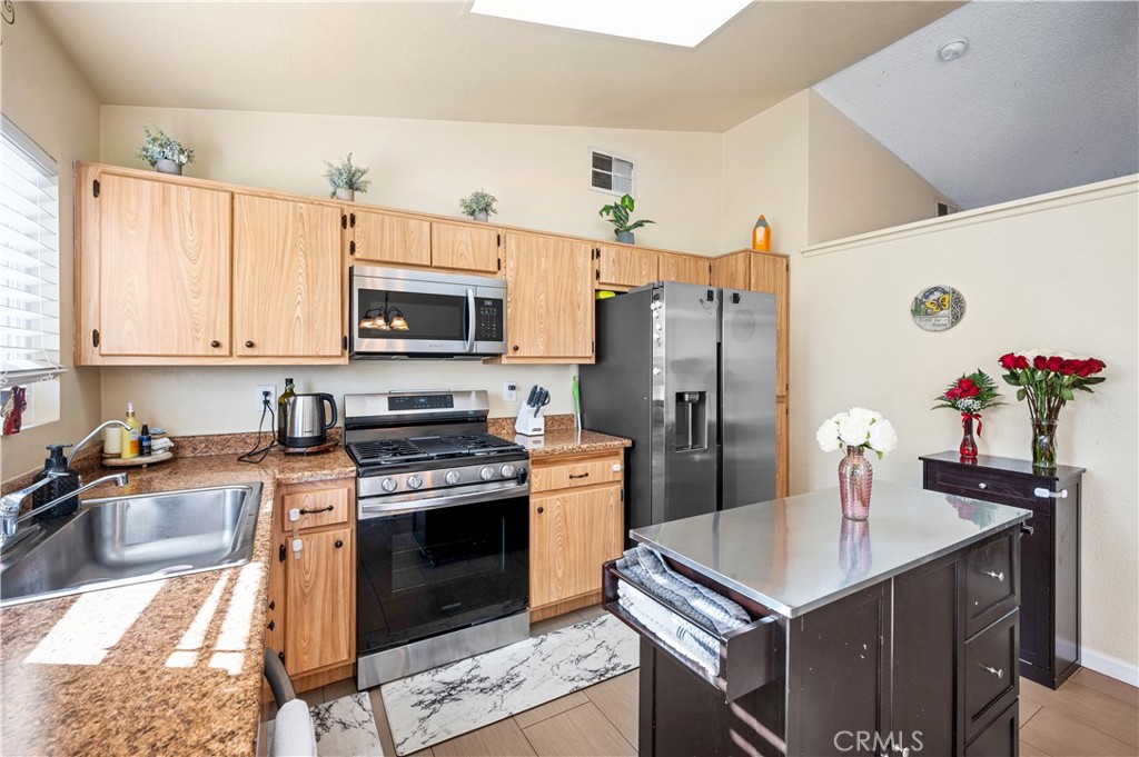 47800 Madison Street, Unit 174 Indio, CA 92201 - Photo 7 of 24 a kitchen with a sink stove and refrigerator