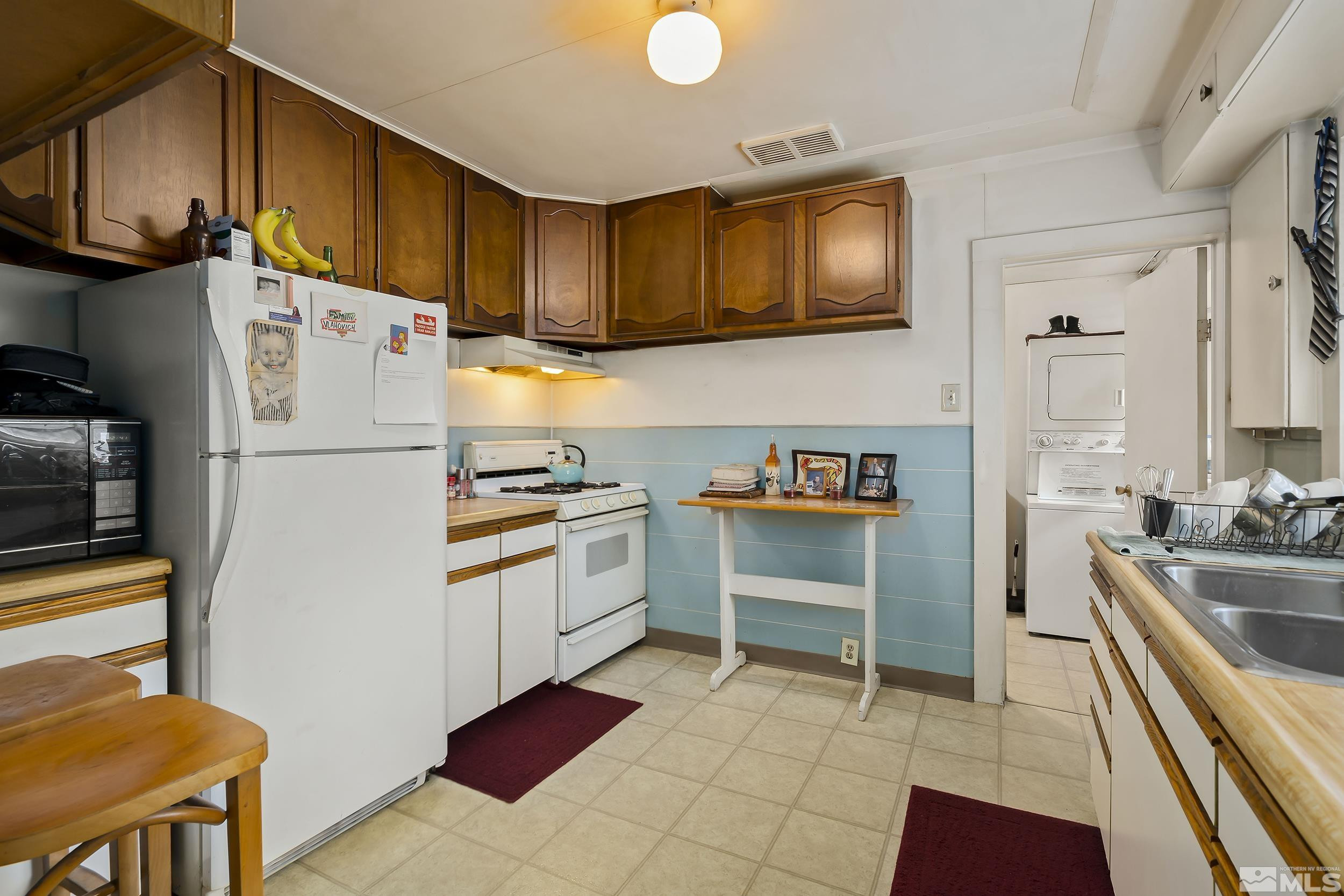 1078 Haskell Street Reno, NV 89509 - Photo 7 of 15 a kitchen with a refrigerator and a sink