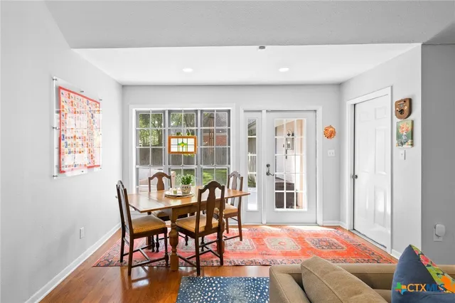 a dining room with furniture and wooden floor