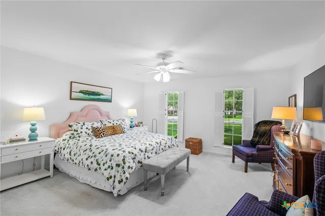 a bedroom with furniture a bed and a chandelier