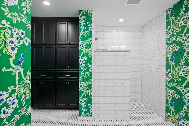 a bathroom with a shower and a plant