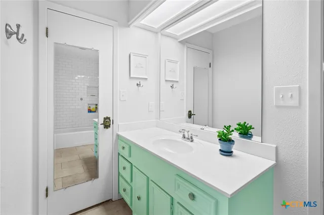 a bathroom with a sink tub and shower