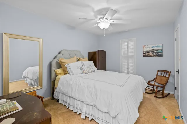 a bedroom with bed and a chandelier