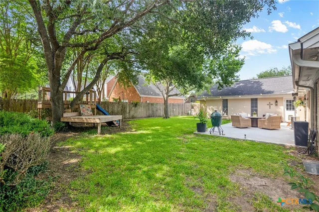 a view of a house with backyard porch and sitting area
