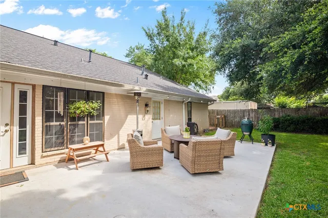 a house view with a sitting space and garden