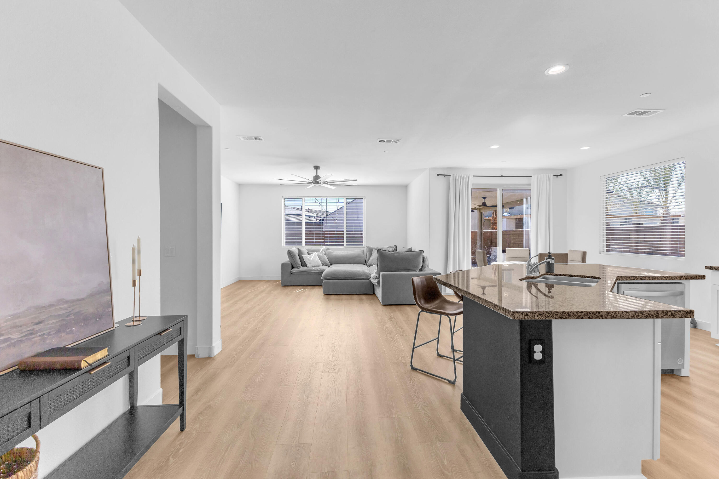 53020 Torino Place Coachella, CA 92236 - Photo 10 of 43 a kitchen with a sink dishwasher a stove and a dining table with wooden floor