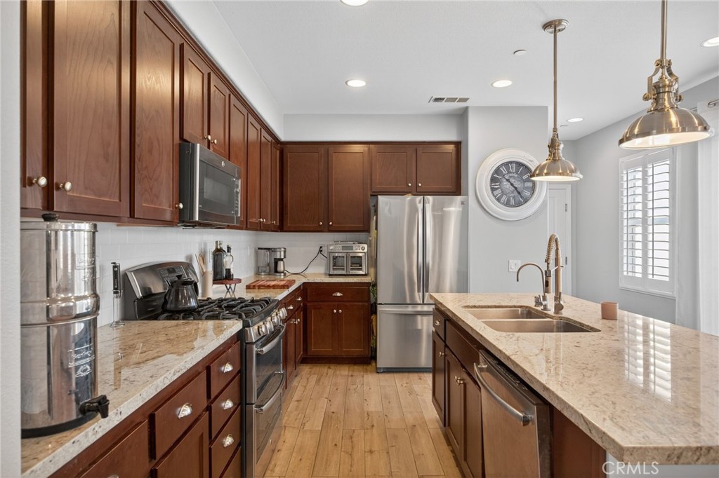 3459 North Oxnard Boulevard Oxnard, CA 93036 - Photo 12 of 54 a kitchen with a sink cabinets and stainless steel appliances