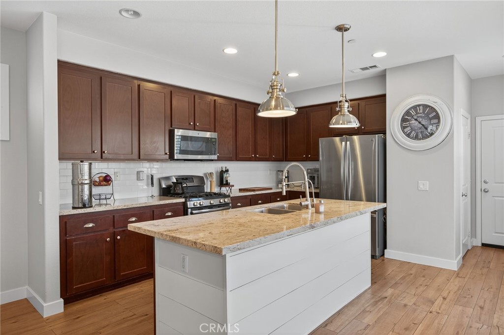 3459 North Oxnard Boulevard Oxnard, CA 93036 - Photo 14 of 54 a kitchen with a sink a stove and cabinets