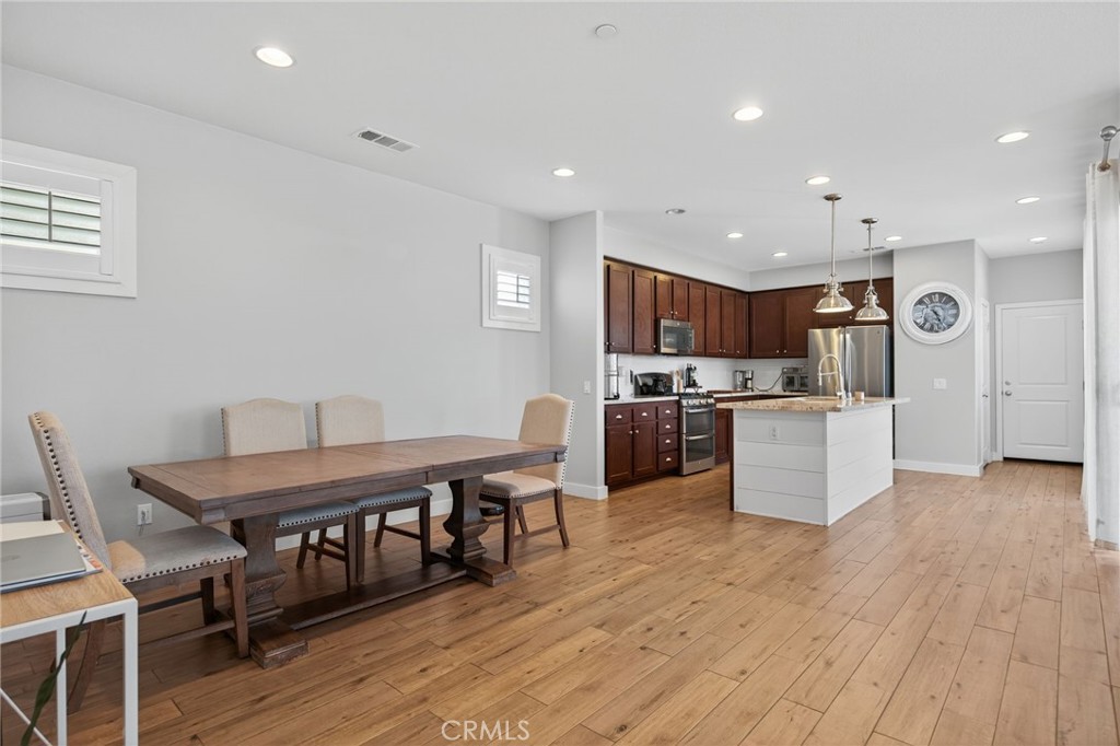 3459 North Oxnard Boulevard Oxnard, CA 93036 - Photo 9 of 54 a living room with stainless steel appliances kitchen island granite countertop furniture wooden floor and a view of kitchen