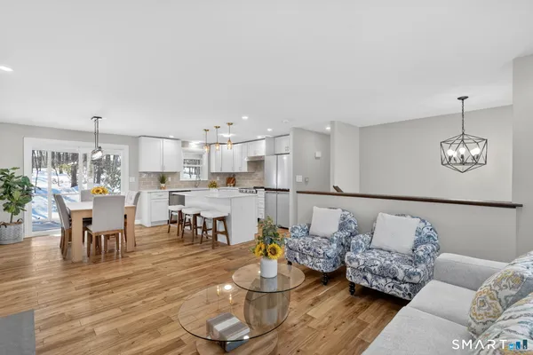 a living room with furniture and kitchen view