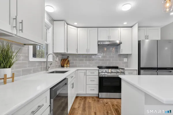 a large kitchen with cabinets table and chairs