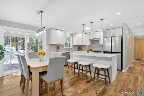 a kitchen with stainless steel appliances granite countertop a sink stove and cabinets
