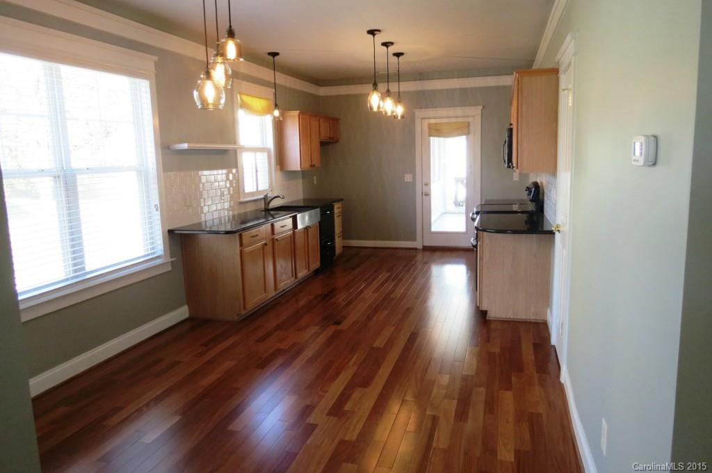 8323 Townley Road Huntersville, NC 28078 - Photo 14 of 23 a kitchen with granite countertop wooden floors and a sink