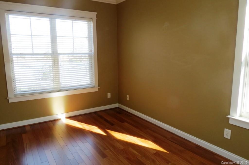 8323 Townley Road Huntersville, NC 28078 - Photo 22 of 23 a view of empty room with wooden floor and fan