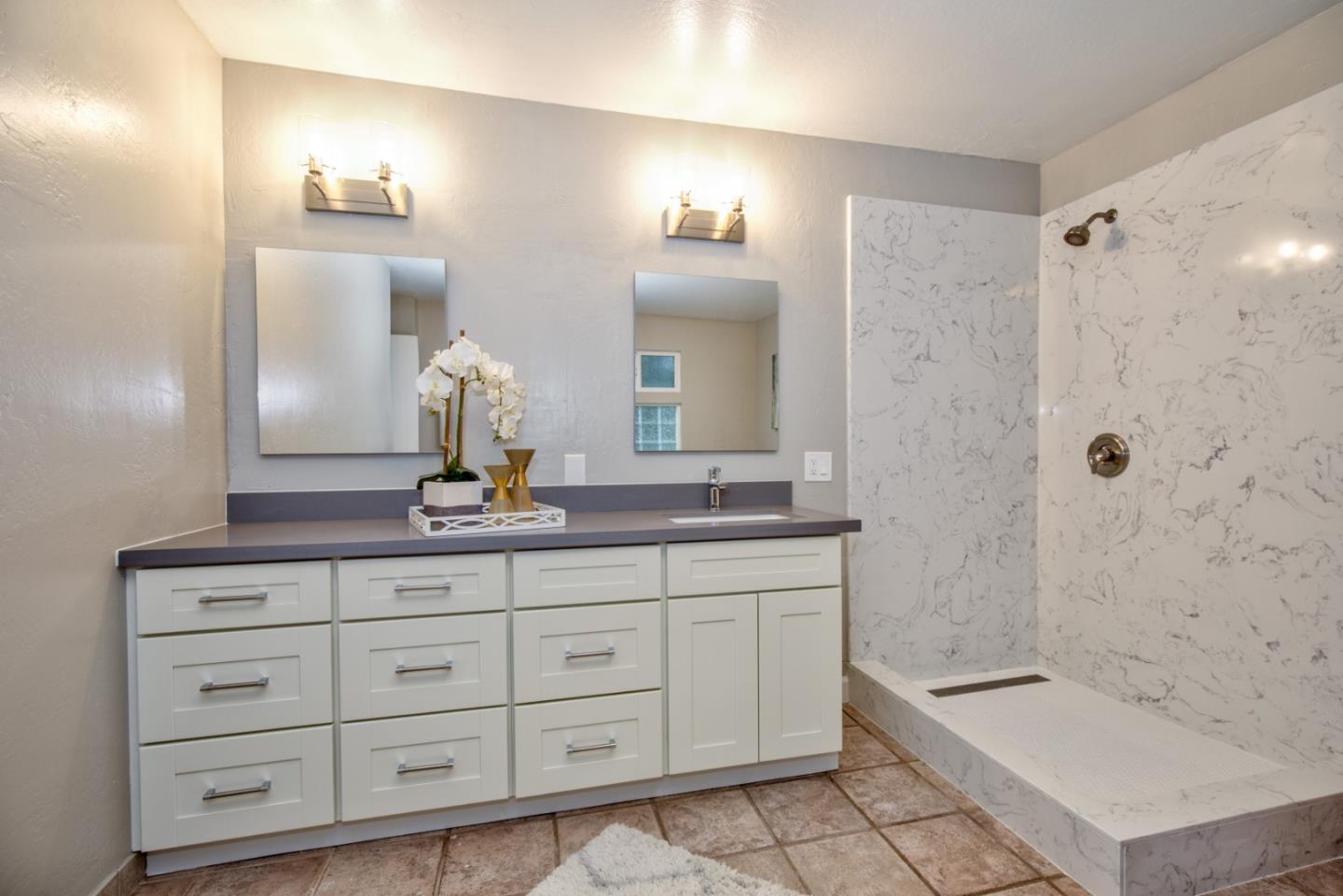 865 Sunset Drive San Carlos, CA 94070 - Photo 15 of 26 a bathroom with a granite countertop sink a toilet a mirror and shower