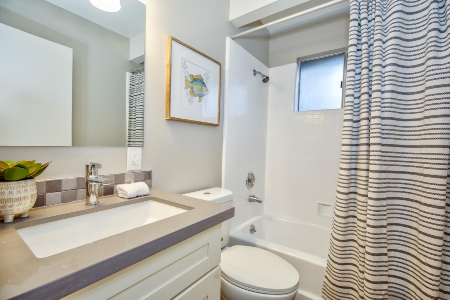 865 Sunset Drive San Carlos, CA 94070 - Photo 17 of 26 a bathroom with a granite countertop sink toilet and shower