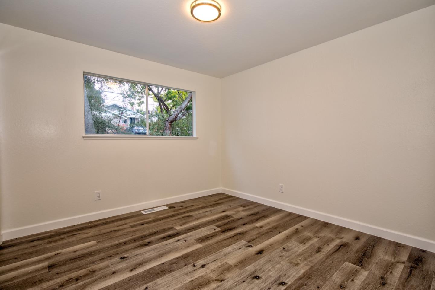 865 Sunset Drive San Carlos, CA 94070 - Photo 18 of 26 a view of a room with wooden floor and window