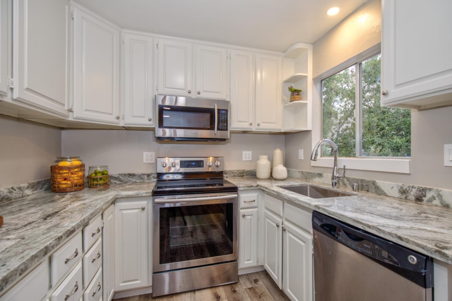 865 Sunset Drive San Carlos, CA 94070 - Photo 8 of 26 a kitchen with granite countertop a sink stove and cabinets