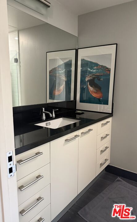 416 South Spring Street, Unit 905 Los Angeles, CA 90013 - Photo 11 of 19 a bathroom with a sink and a mirror