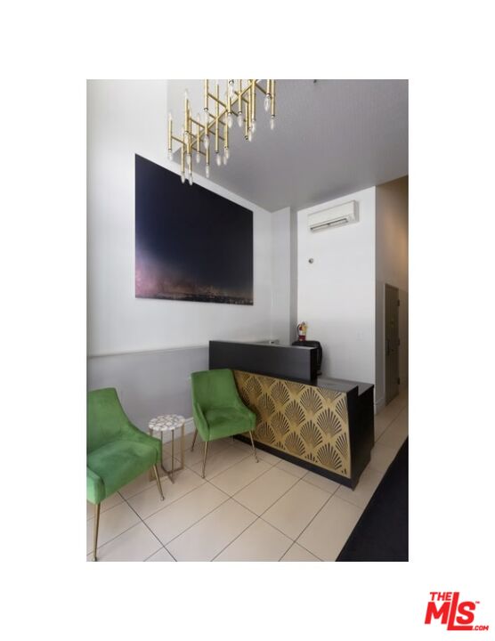 416 South Spring Street, Unit 905 Los Angeles, CA 90013 - Photo 2 of 19 a living room with furniture and a flat screen tv