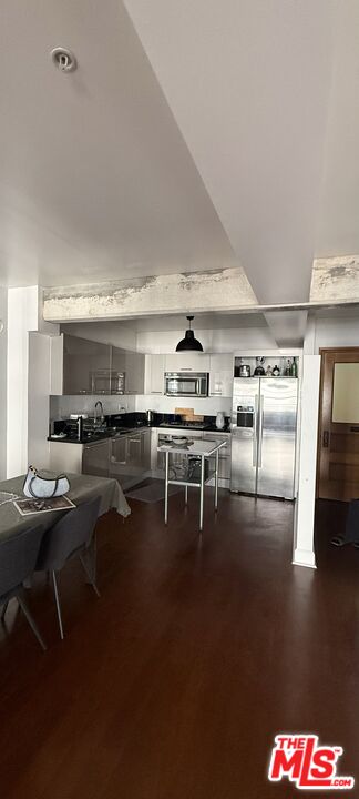 416 South Spring Street, Unit 905 Los Angeles, CA 90013 - Photo 9 of 19 a room with stainless steel appliances lots of wooden furniture and empty room