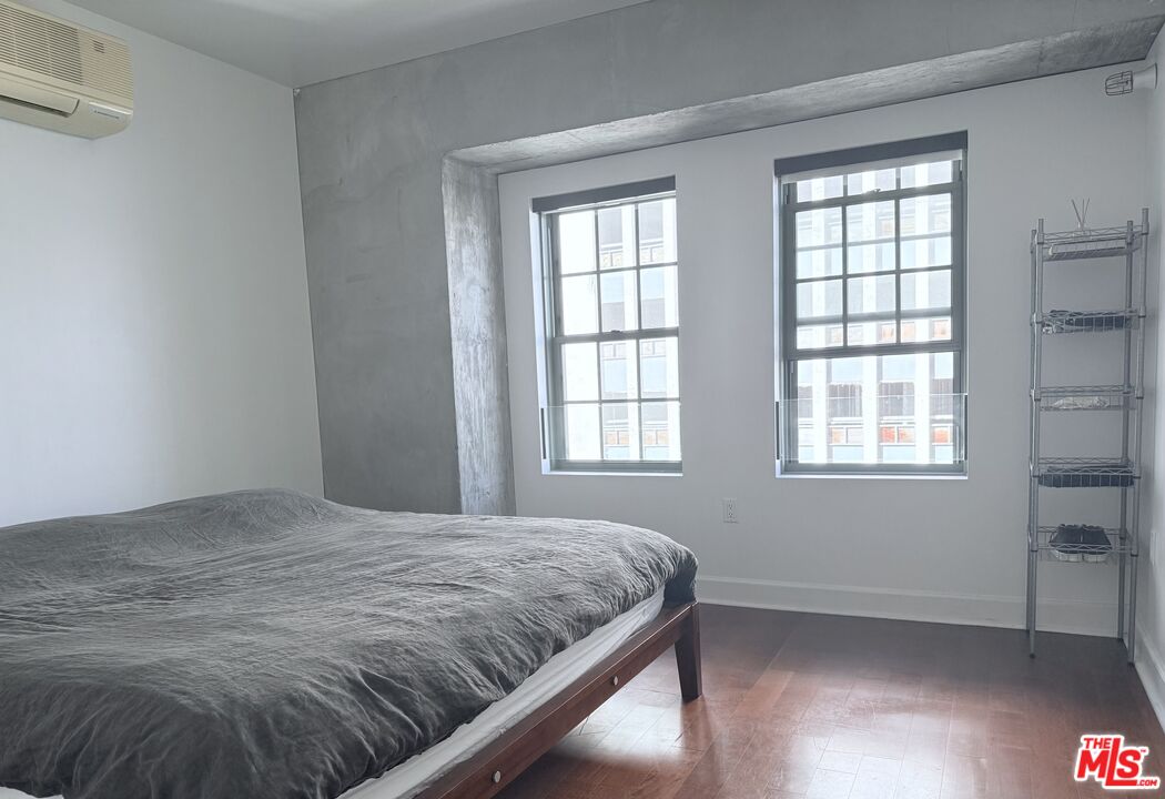 416 South Spring Street, Unit 905 Los Angeles, CA 90013 - Photo 10 of 19 a bedroom with a bed and window