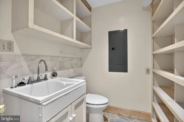 a bathroom with a sink a vanity and a large mirror