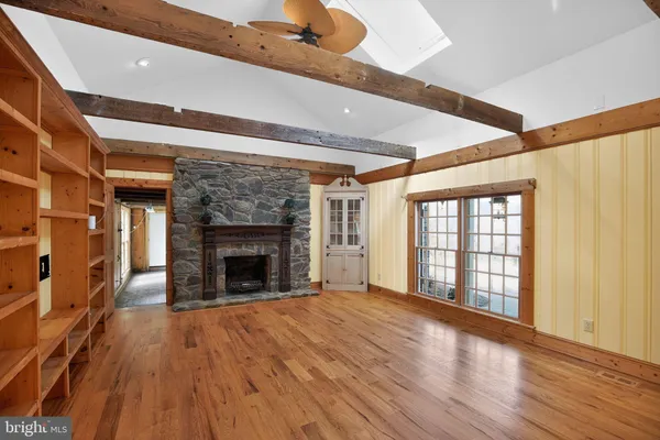 a spacious bathroom with a mirror and a sink