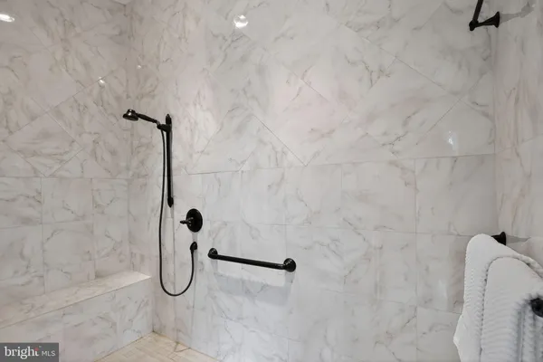 a view of a hallway with a chandelier fan and wooden floor