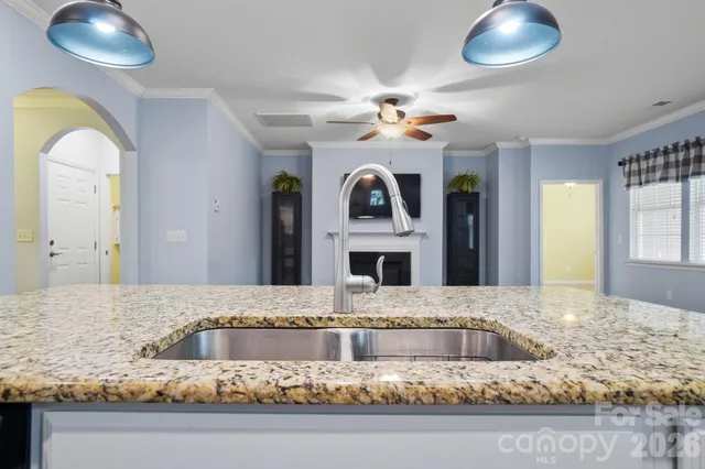 a living room with a granite countertop furniture and a fireplace
