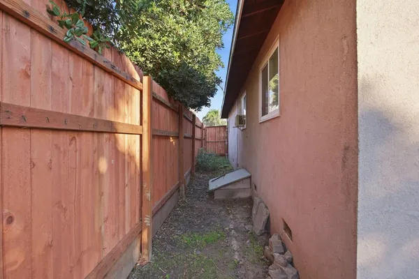 a view of a pathway along with wooden fence