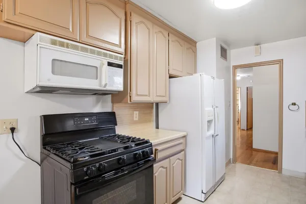 a kitchen with stainless steel appliances granite countertop a stove and a refrigerator