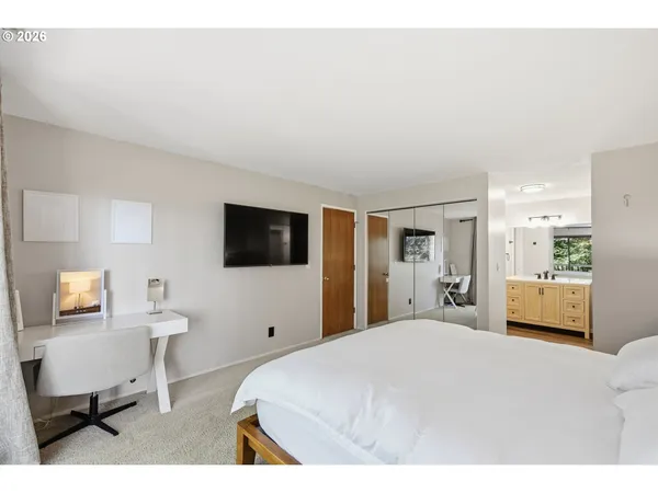 a bathroom with a granite countertop sink toilet a mirror a vanity and shower