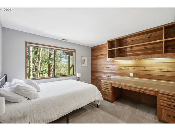 a bedroom with a large bed and a window