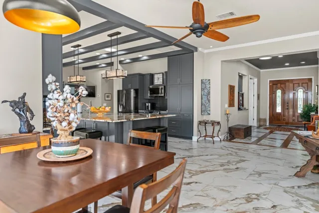 a view of a dining room with furniture and chandelier