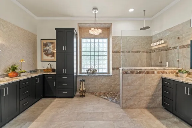 a bathroom with a granite countertop sink a toilet a mirror and window